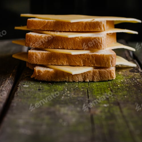 Preview: Slices Of Cheese And Bread On Wooden Background