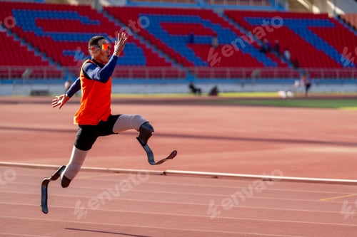 Preview: Asian para-athletes with prosthetic blades sprint on a running track at stadium.
