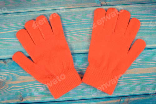 Preview: Red woolen gloves for woman on boards, clothing for autumn or winter concept