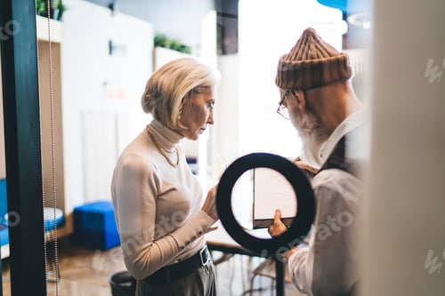 Preview: Elderly colleagues collaborating in spacious office