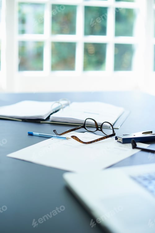Preview: Laptop, eyeglasses and diary on dining room table