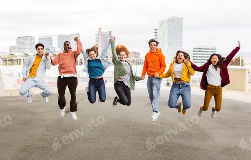 Preview: Diverse happy group of young friends jumping together outdoors