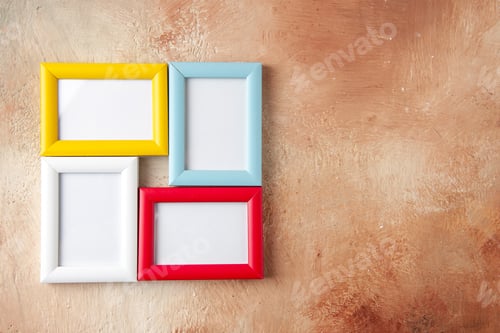 Preview: Front close view of colorful picture frames hanging on nude color wall with free space
