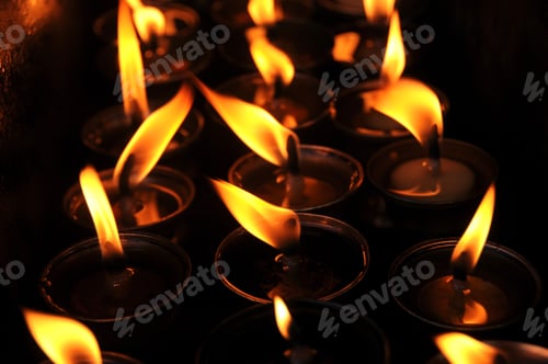 Preview: Butter lamps with flames near Bodhnath stupa in Kathmandu, Nepal