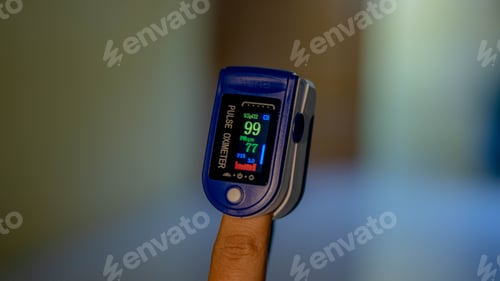 Preview: Closeup shot of a person's finger in a pulse oximeter