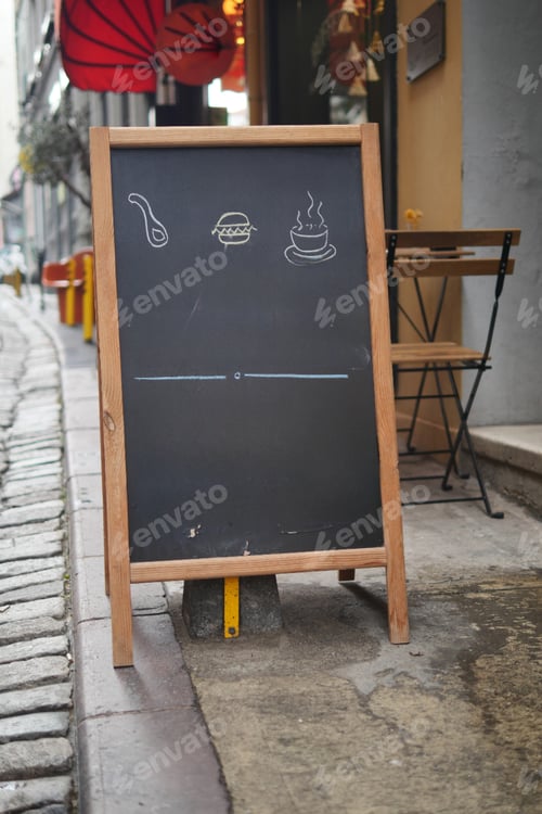 Preview: Empty wooden blackboard mockup standing outdoors in front of cafe