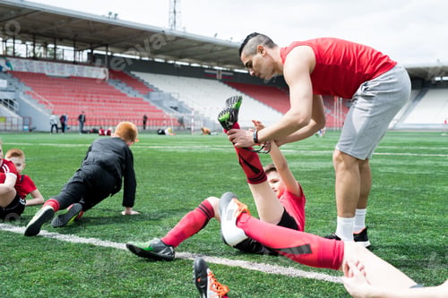 Preview: Junior Football Team Stretching at Practice