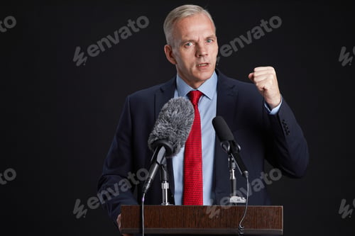 Preview: Passionate Mature Man Giving Speech at Podium