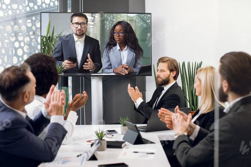 Preview: Team of five diverse business people, start up developers, clapping hands while attending