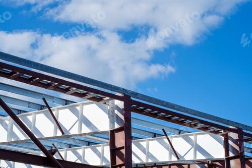 Preview: New building construction metal steel frame, daylight with blue sky and clouds