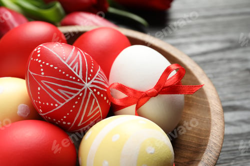 Preview: Bowl with painted Easter eggs on table, closeup