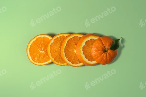 Preview: Slices of fresh ripe orange arranged in row on soft green background, symbolizing juicy refreshment