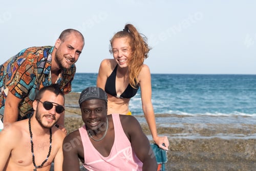 Preview: Group of young guys looking at camera on the beach