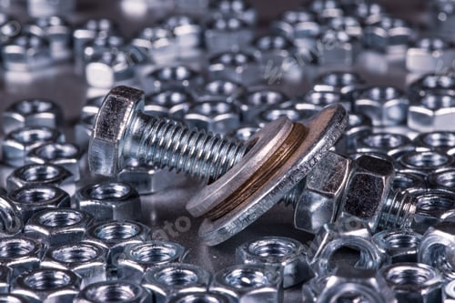 Preview: Metal chrome bolts and nuts in a chaotic order industrial background