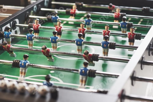 Preview: Table football in the entertainment center. Close-up image of plastic players in a football game
