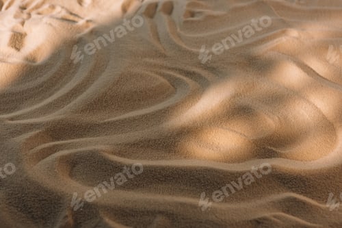 Preview: High angle view of textured sand with sunlight