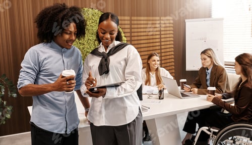Preview: Business team working together with charts and technology in modern office environment