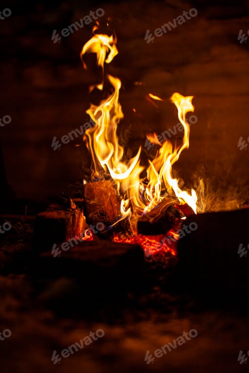 Preview: A campfire burns in the snow at night in the snow in the cold winter