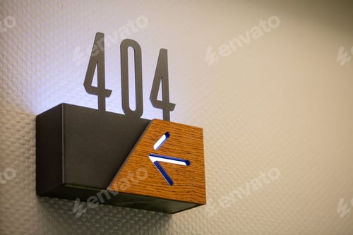 Preview: Closeup of 404 hotel room number with an arrow sign showing the direction
