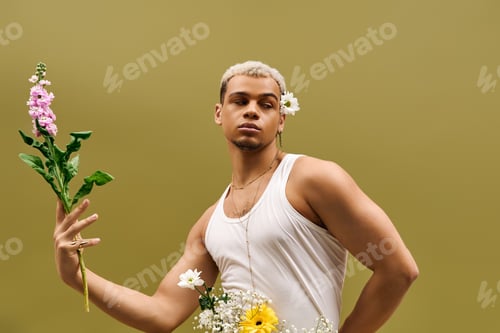 Preview: Captivating young man exudes style with flowers in vibrant studio setting