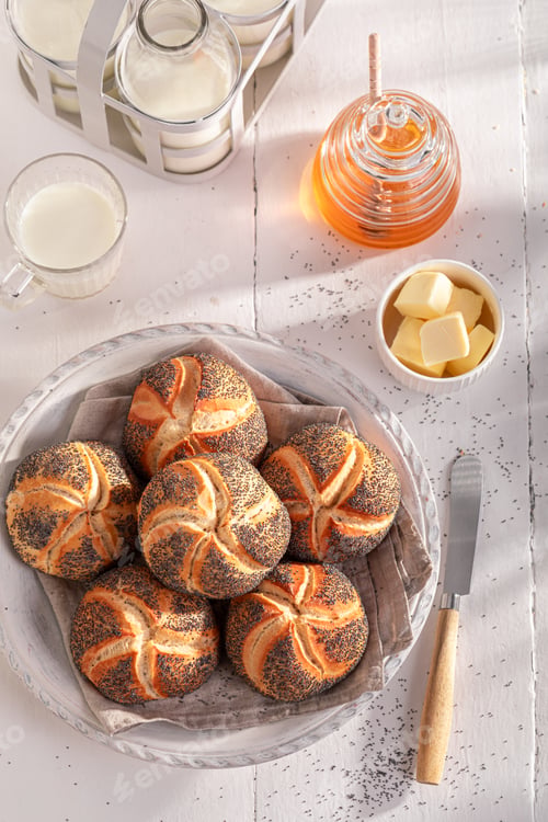 Preview: Tasty Kaiser buns with poppy seed served with milk.