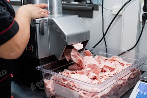 Preview: cook cutting sausages for pizza