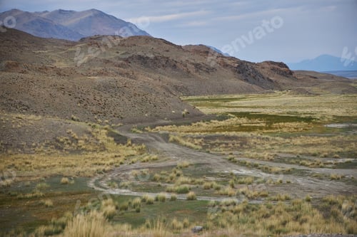 Preview: Views of a dry landscape with hills and grass in a remote area during daylight