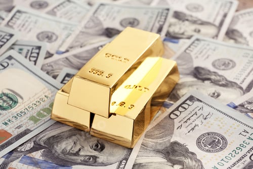 Preview: Shiny gold bars on pile of dollar bills
