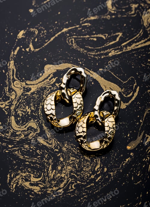 Preview: Golden chains earrings on black background.