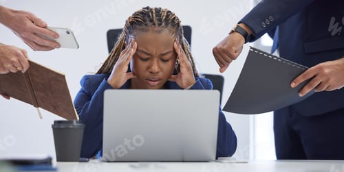 Preview: Shot of a young businesswoman looking stressed out in a demanding office environment