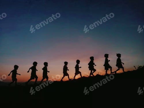 Preview: Silhouette of a group of children walking up a hill at dusk time.