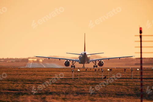 Preview: Airplane is on runway ready for take off. Traffic at airpot at sunset.
