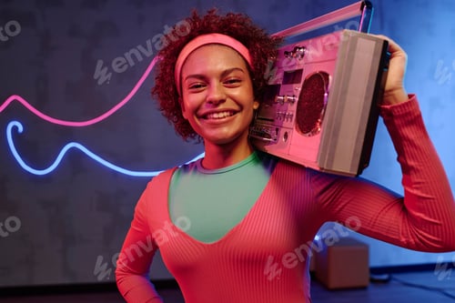 Preview: Sportive Girl Holding Vintage Boombox on Her Shoulder