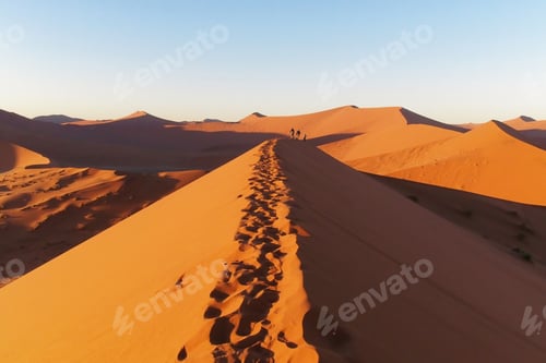 Preview: Picturesque view of a dune with footprints in the Namib Desert, Namibia on clear blue sky background