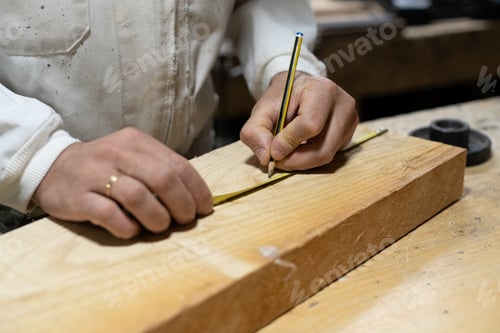 Preview: Cabinetmaker marking with pencil on a piece of wood