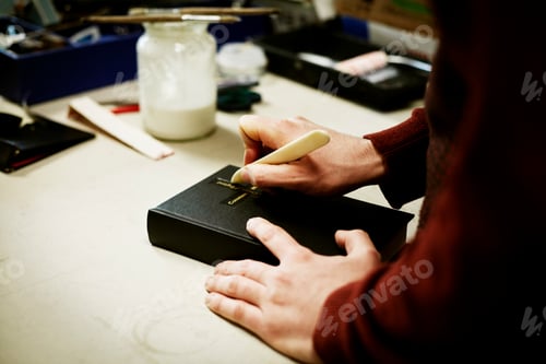 Preview: A man using a small handheld tool on the cover of a book.