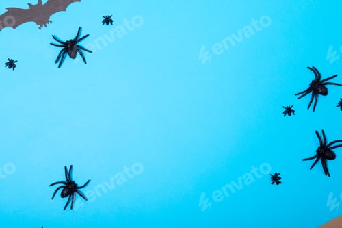 Preview: Multiple spider and bat toys with copy space on blue background