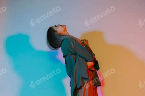 Preview: Woman expressing emotion under colorful neon light