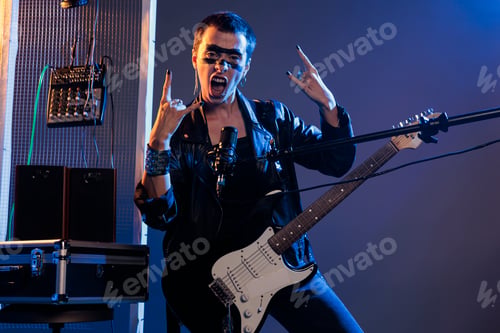 Preview: Punk rocker doing rock sign on live performance