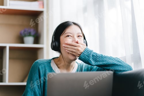 Preview: Smart and positive Asian female freelancer or female college student sitting on sofa with laptop. St
