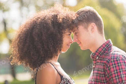 Preview: Young couple face to face in park