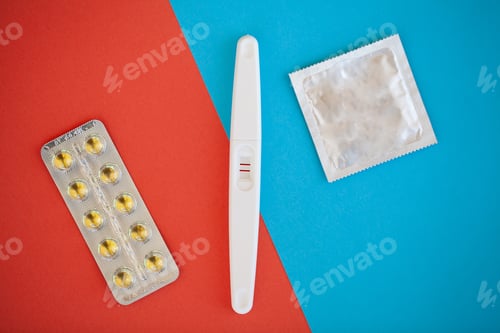 Preview: Pregnancy test. The result is positive with two strips and condom with contraceptive