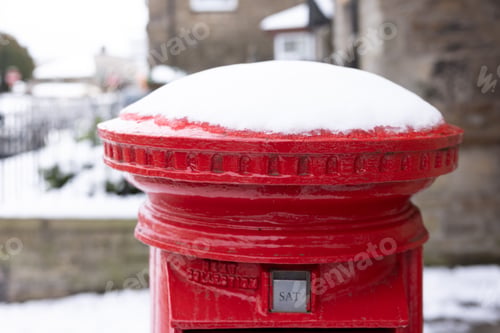 Preview: Red post box covered with snow in winter setting