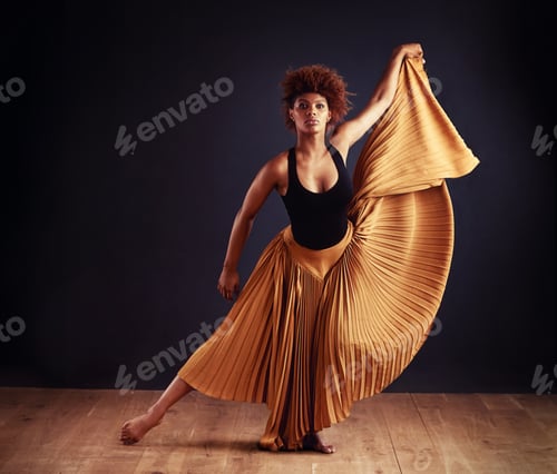 Preview: Strong and elegant. Female contemporary dancer in a dramatic pose against dark background.