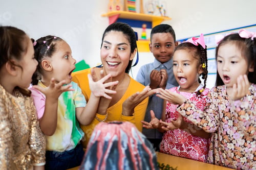 Preview: Teacher and children learn about volcanos at science kindergarten. kids study at school. Education
