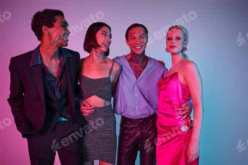 Preview: joyful interracial men in festive attire and women in dresses celebrating Christmas on purple pink