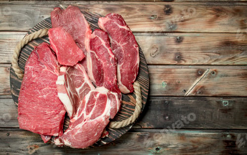 Preview: Raw meat. Beef and pork steaks on the Board.