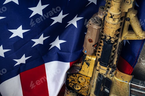 Preview: U.S. battle flag and assault rifle near the wall. close up