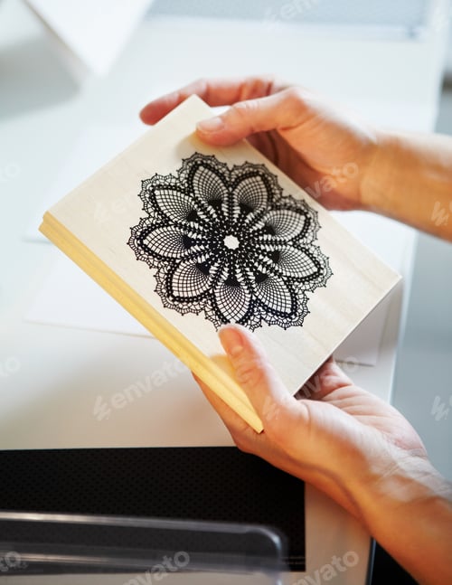 Preview: Home craft printing options. Cropped shot of a womans hands holding a wooden craft stamp.