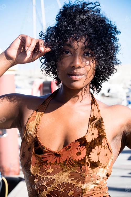 Preview: Portrait of attractive black young woman with summer dress looking on camera.